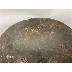 Indian black lacquered hide shield/dhal, of circular convex form fitted at its centre with four pierced iron bosses, each of hemispherical form with wide brims, the bosses corresponding on the inside with four iron rings for enarmes D53.5cm