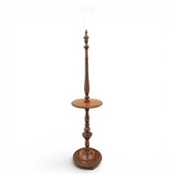 Late Victorian set of two oak standard lamps, turned and carved column supports, one with foliate carved panelled stem, on stepped square bases with carved scroll feet, the other on circular moulded spreading base