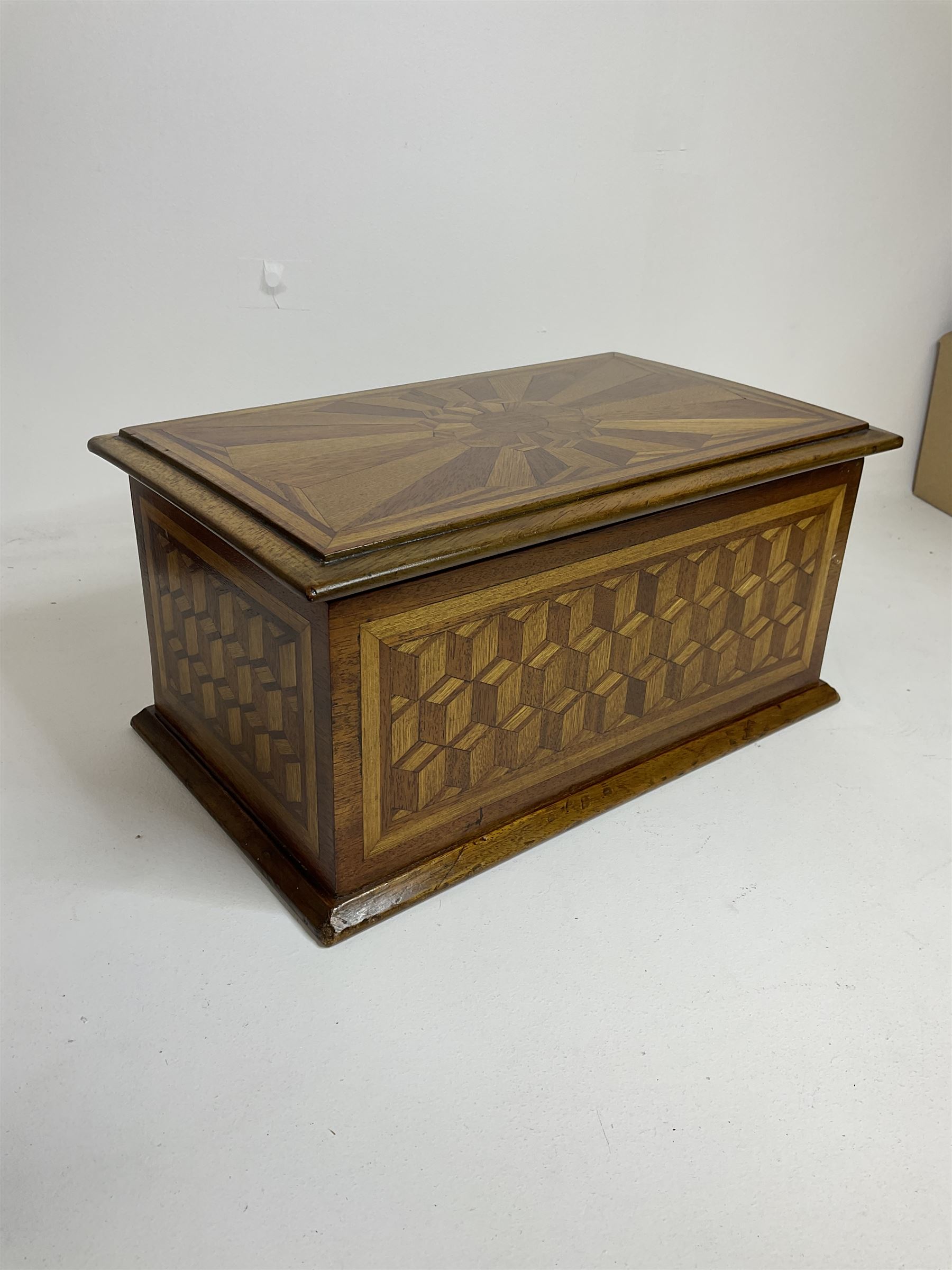 19th Century mahogany and parquetry box of rectangular form, geometric cube design, with a stylised sun detail to the hinged cover, opening to reveal three compartments, L33cm D21cm H16cm
