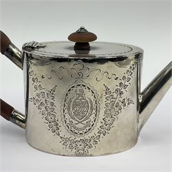 George III silver bachelors teapot, of oval form with wooden scroll handle and finial, the body chased with armorial crest and ribbon swag and foliate detail, hallmarked Samuel Godbehere & Edward Wigan, London 1793, including handle H9cm