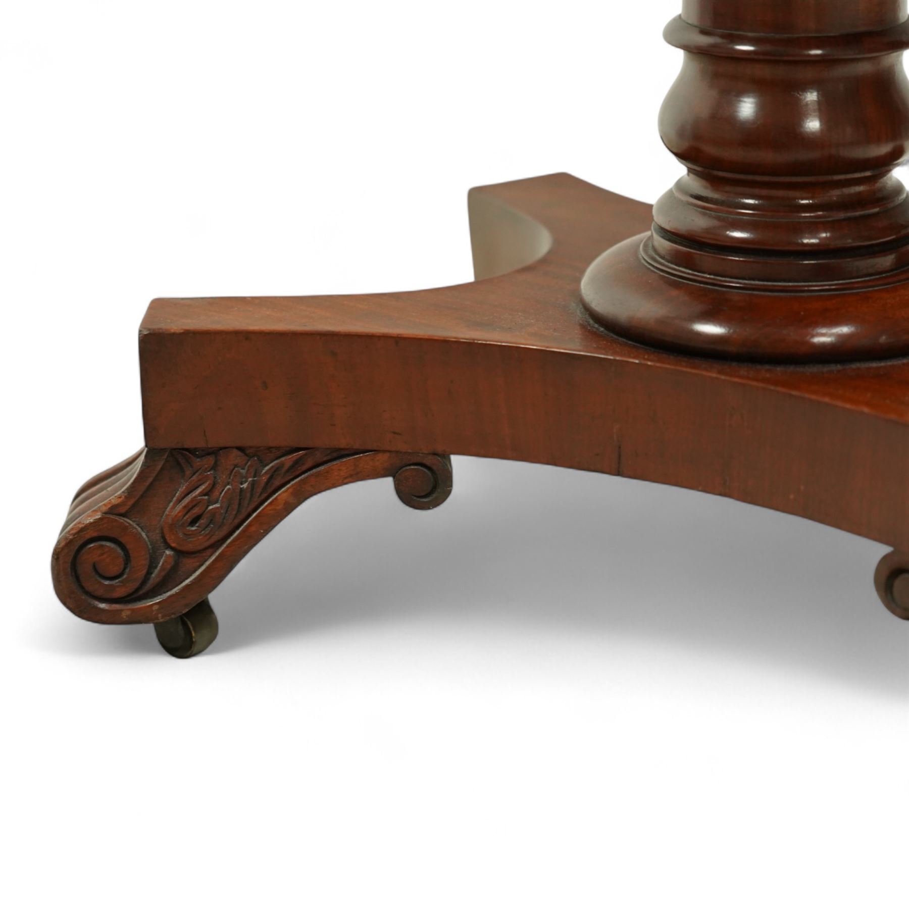 Late Regency mahogany side table in the manner of Gillows, the rectangular top with pierced brass gallery, raised on a reeded column and quatreform base with scroll carved feet with castors 