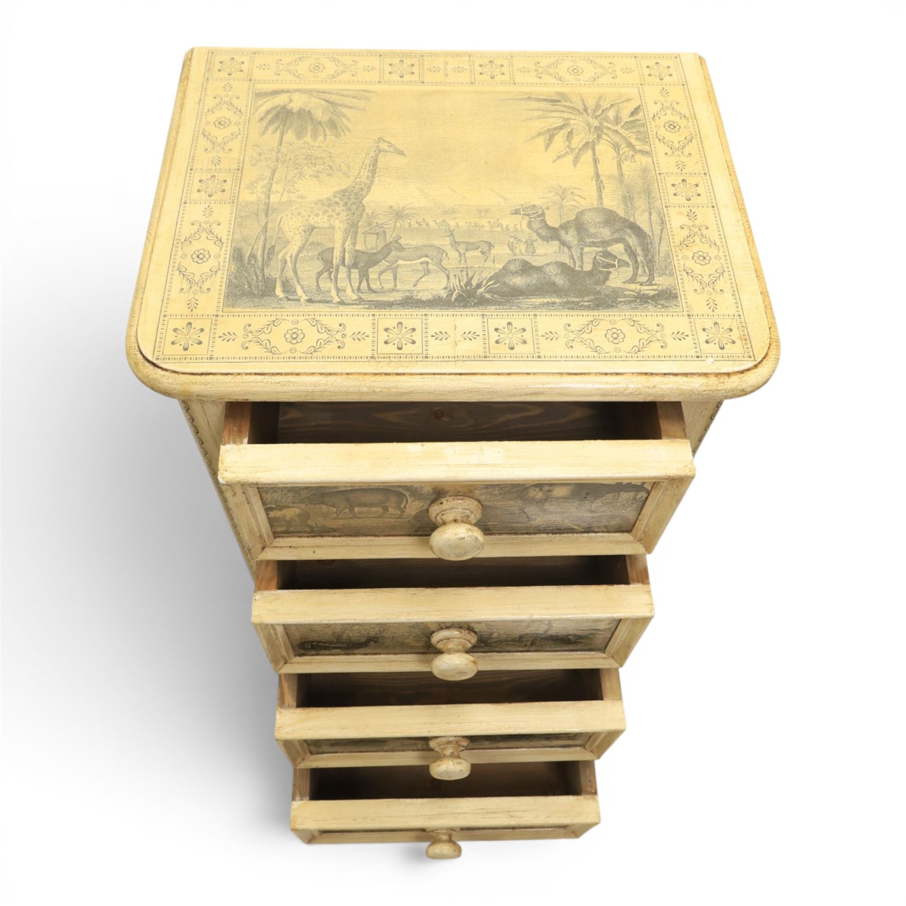 Traditional design cream painted lacquered pedestal chest, rounded moulded top over four short drawers, the drawer fronts decorated with monochrome printed animal scenes, conforming foliate and geometric borders to the top and sides, turned handles, on bun feet