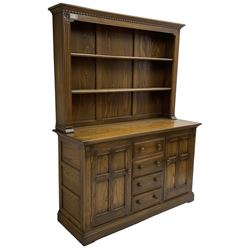 Ercol - mid-20th century dark elm 'Old Colonial' dresser, two tier plate rack with fluted uprights, base fitted with four drawers flanked by two panelled cupboards