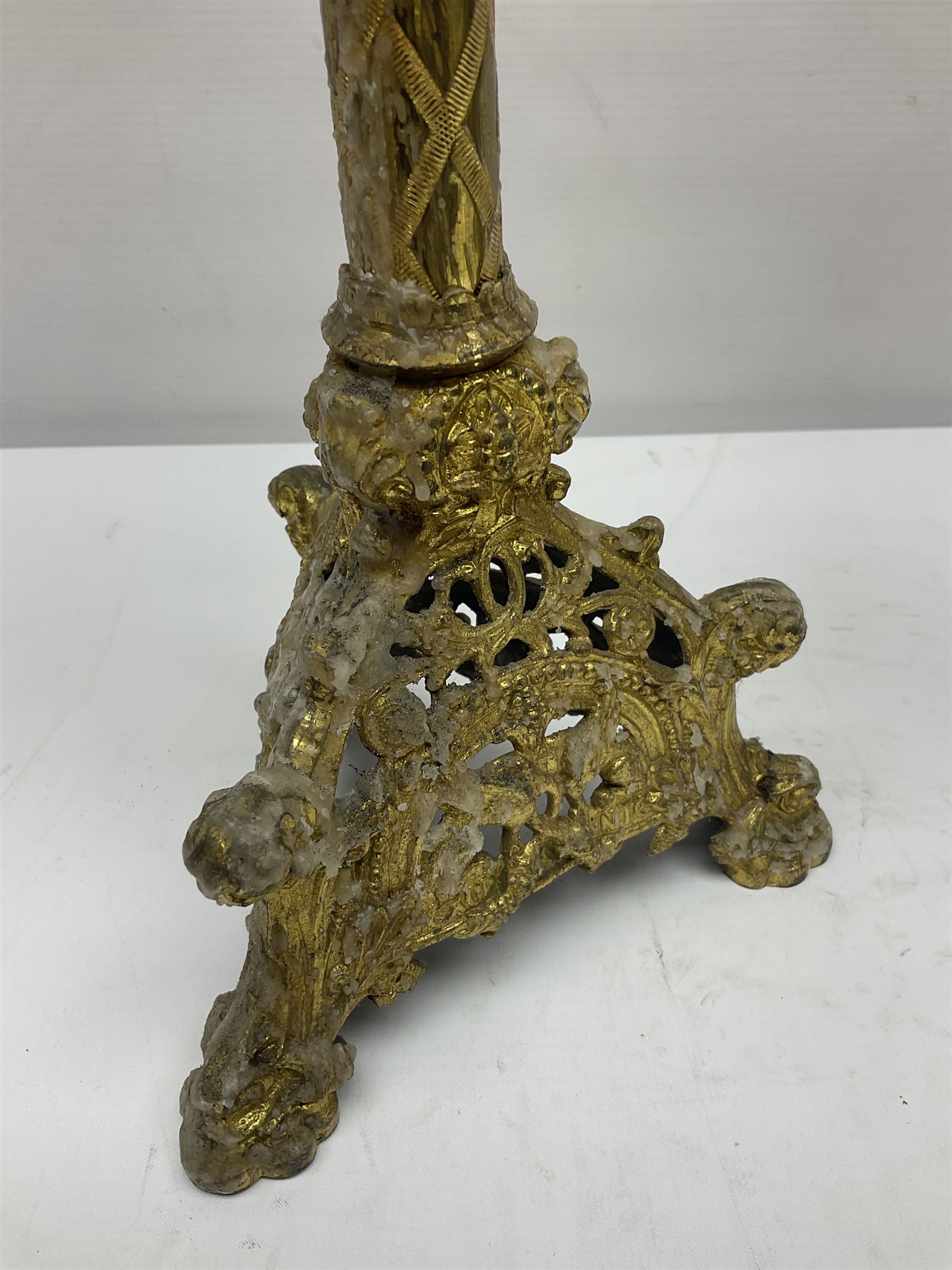 Pair of gilt metal pricket candlesticks, with applied decoration on knopt stems and triform bases, H47cm