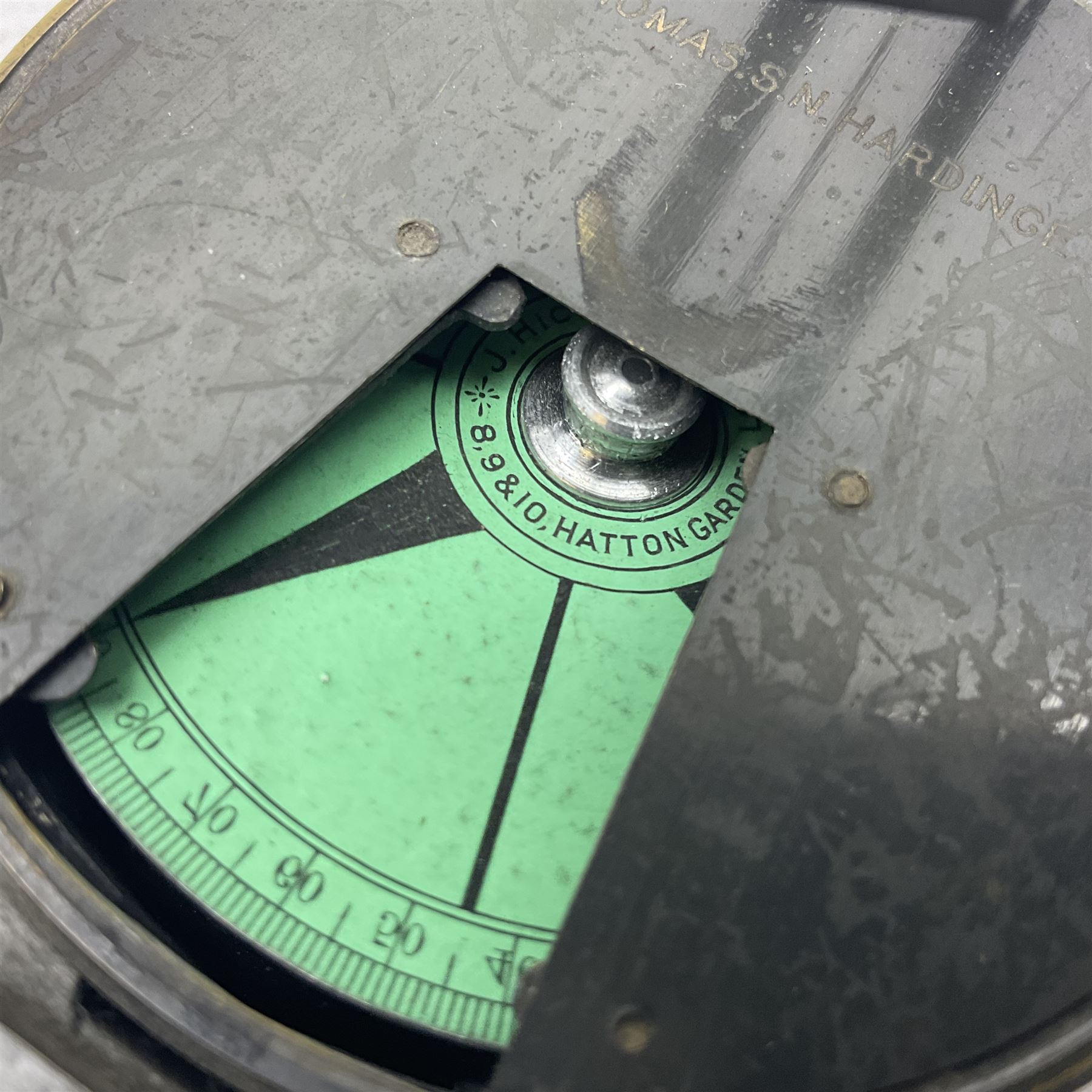 19th century Watkins combined clinometer and compass, patent 217, by J. Hicks Maker 8 Hatton Garden London No.5829, of drum shaped form in lacquered brass case D7cm; both instrument and case bear the name of former owner Thomas S.N. Hardinge; with early 20th century postcard caricature of a serviceman (2)