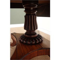  Regency mahogany drop leaf supper table, single column on quatrefoil base, reeded sabre supports with brass capped hairy paw feet on castors, W114cm, H73cm, D107cm  