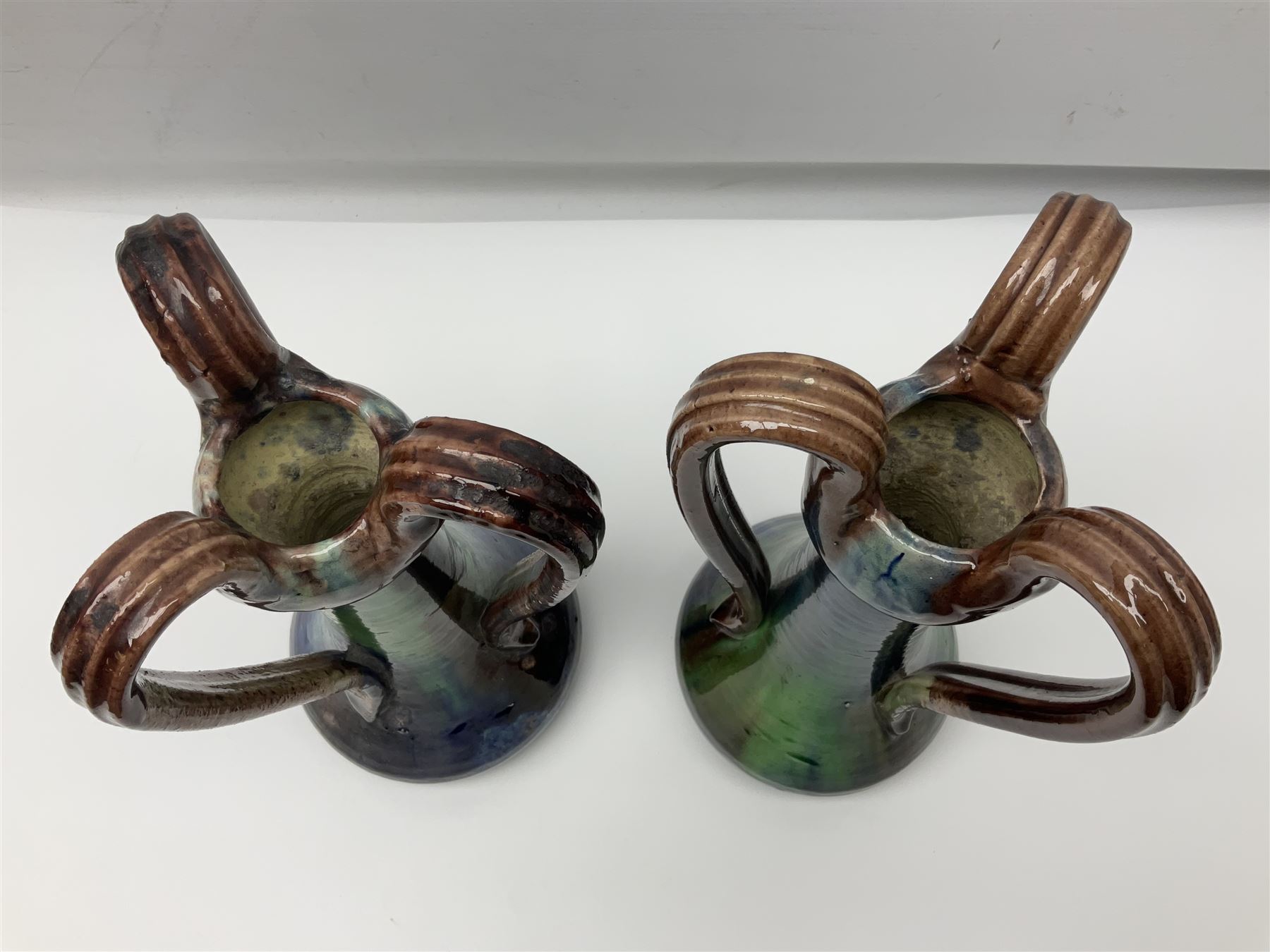 Pair of Art Nouveau style vases, probably Belgian, each with merging blue, brown and green decoration and three handles, impressed LSV beneath, H32cm