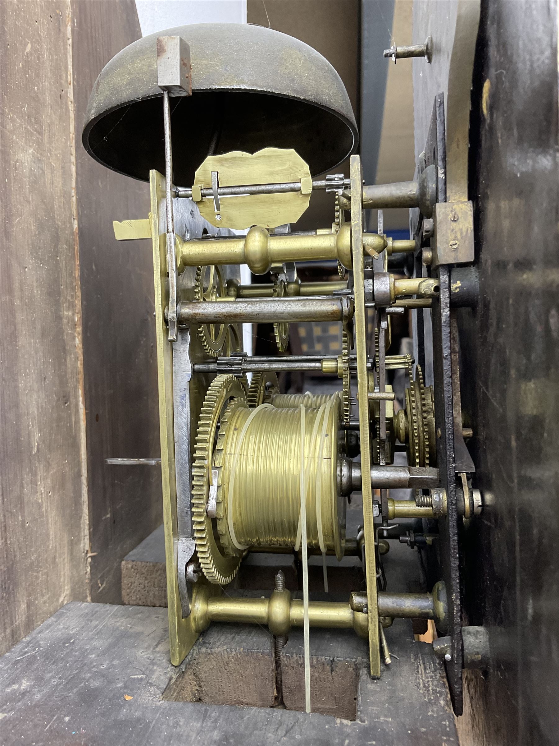 W Sargent of Boston (Lincs) - late 18th century oak cased 8-day longcase clock, with a deep swans necked pediment and brass paterie, break arch hood door with a dog tooth moulding above and detached reeded pilasters with brass capitals, trunk with canted corners and recessed pilasters, long trunk door with a pointed top and central lock escutcheon, on a shortened plinth with applied skirting, painted dial with a moon disc to the arch and spandrels with depictions of fruit within gesso borders, Roman numerals with Arabic five minutes and matching steel hands, date aperture and seconds dial, dial pinned via a false plate to a rack striking movement, striking the hours on a cast bell. With pendulum and weights.