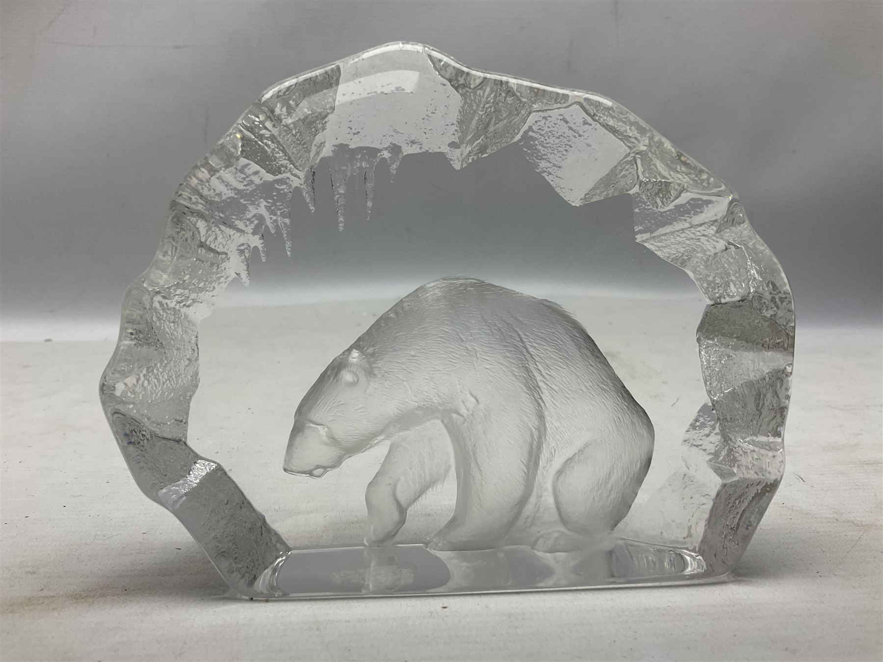 Two Mats Jonasson, Sweden paperweights, comprising polar bear in ice cave no 3152 and lion cubs, both with etched marks beneath, tallest H11.5cm
