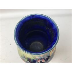 Moorcroft vase of baluster form decorated in the Spring Flowers pattern upon a merging green and blue ground, with impressed and painted marks beneath, H22.5cm