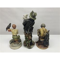 Three Capodimonte figures, to include The Kind Heart Man, modelled by Cortese as a tramp with two doves, The Young Falconer by Maria Angela and another modelled as a tramp darning his socks, all with printed marks, tallest H39cm