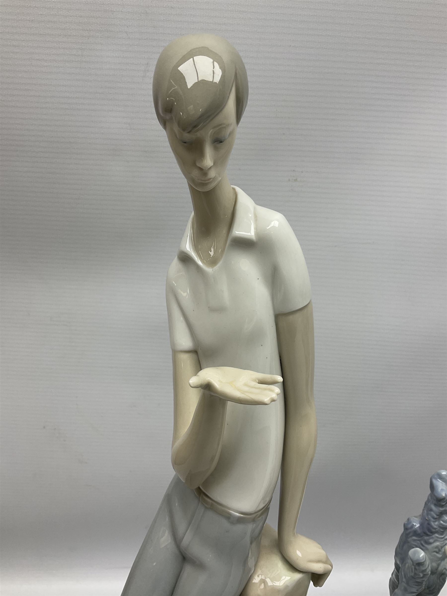 Four Lladro figures, comprising Touch of Class no 5377, Boy Student no 4517, Ocean Beauty no 5785 and Carnival Couple no 4882, largest example H45cm