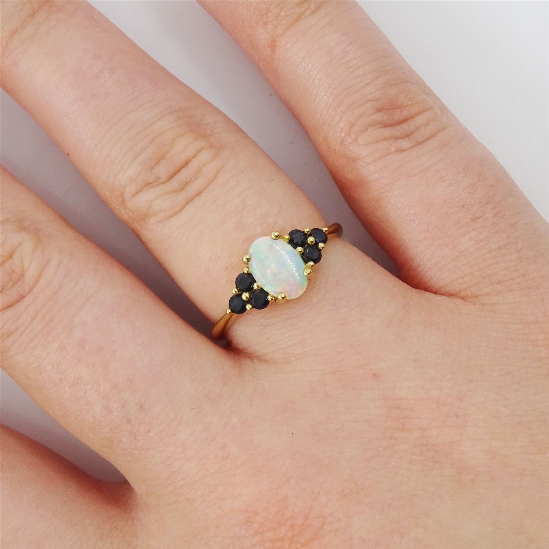9ct gold opal and sapphire ring, single oval cut opal, with three sapphires set either side, hallmarked