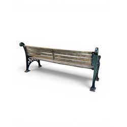 Neoclassical design cast iron and oak slatted garden bench, the twin end supports in the form of a Sphinx with acanthus carved knees and large paw feet, the pierced lattice bracket with Yorkshire rose motifs