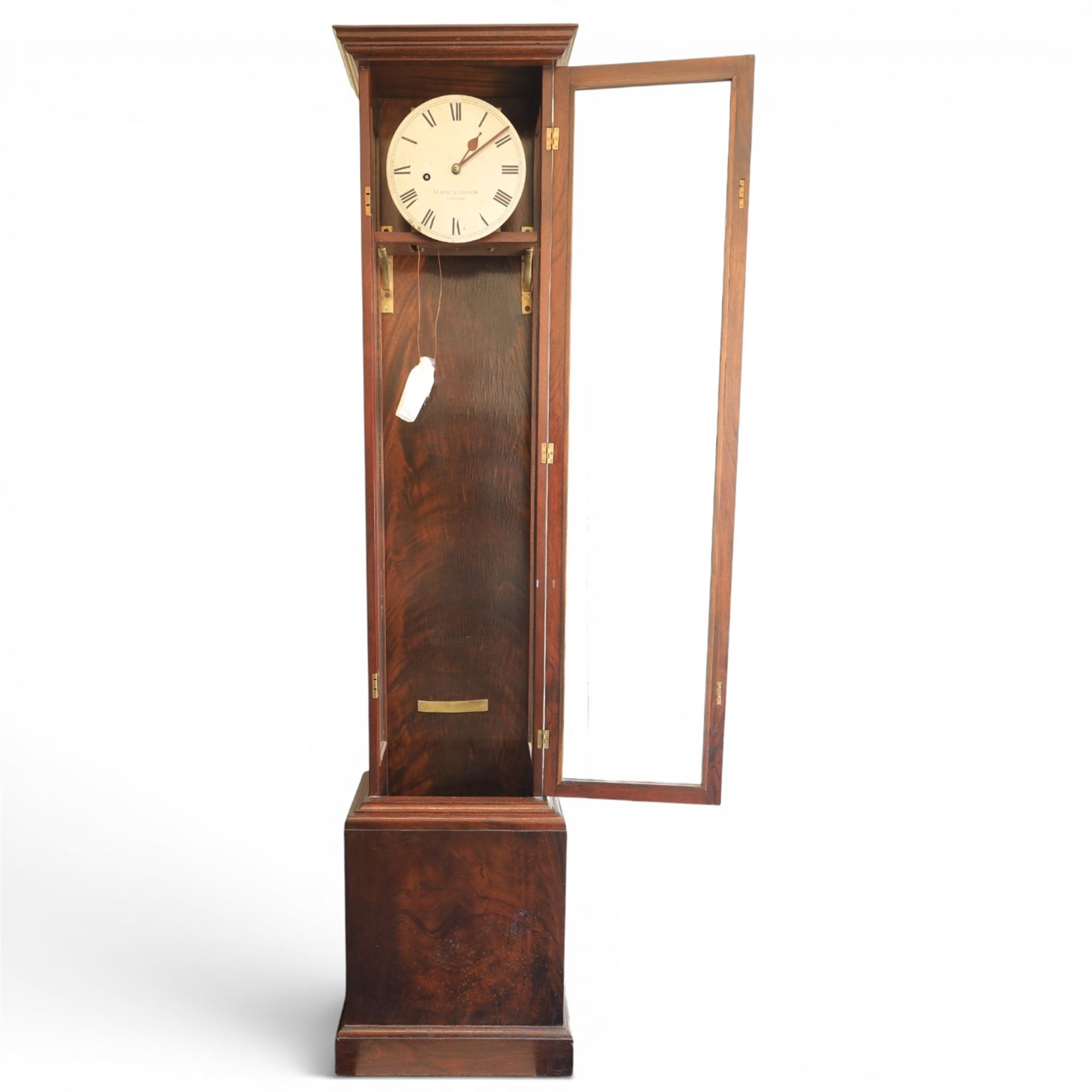 Edwardian mahogany regulator longcase clock, retailed by Maple & Co. Ltd., London, moulded cornice over glazed case enclosing a circular painted Roman numeral dial, single train weight-driven movement with brass cased weight and pendulum, on plinth base