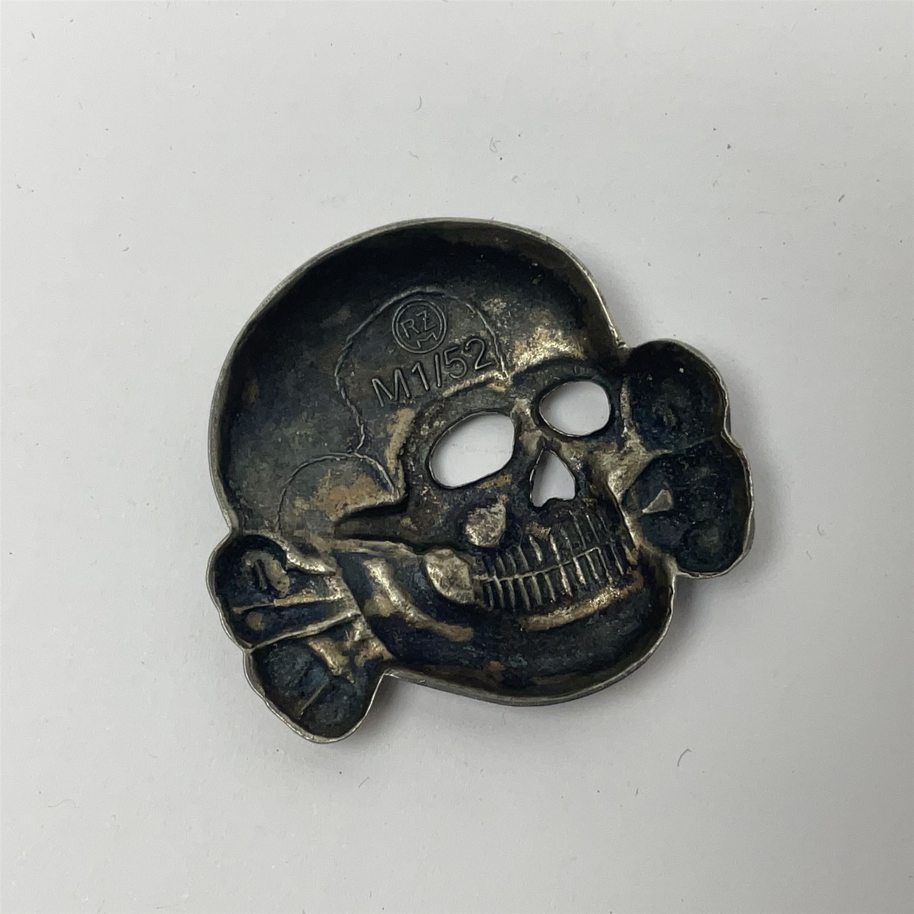 Collection of approximately sixty worldwide medals, metal badges, belt buckles, cloth badges, trench art, brass button stick etc