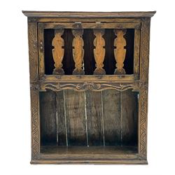 17th/18th century boarded oak wall hanging open shelf or glass cupboard, with projecting cornice above a single door with series of shaped splats, leaf carved upright decoration to sides, and central stretcher rail carved in relief with floral decoration above an open shelf, H62cm W52cm D17cm 