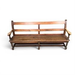Early 20th century pine and oak bench seat, stained pine rail back frame with shaped oak arms