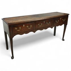 George III oak dresser base, fitted with three drawers with brass swan-neck handles, shape...