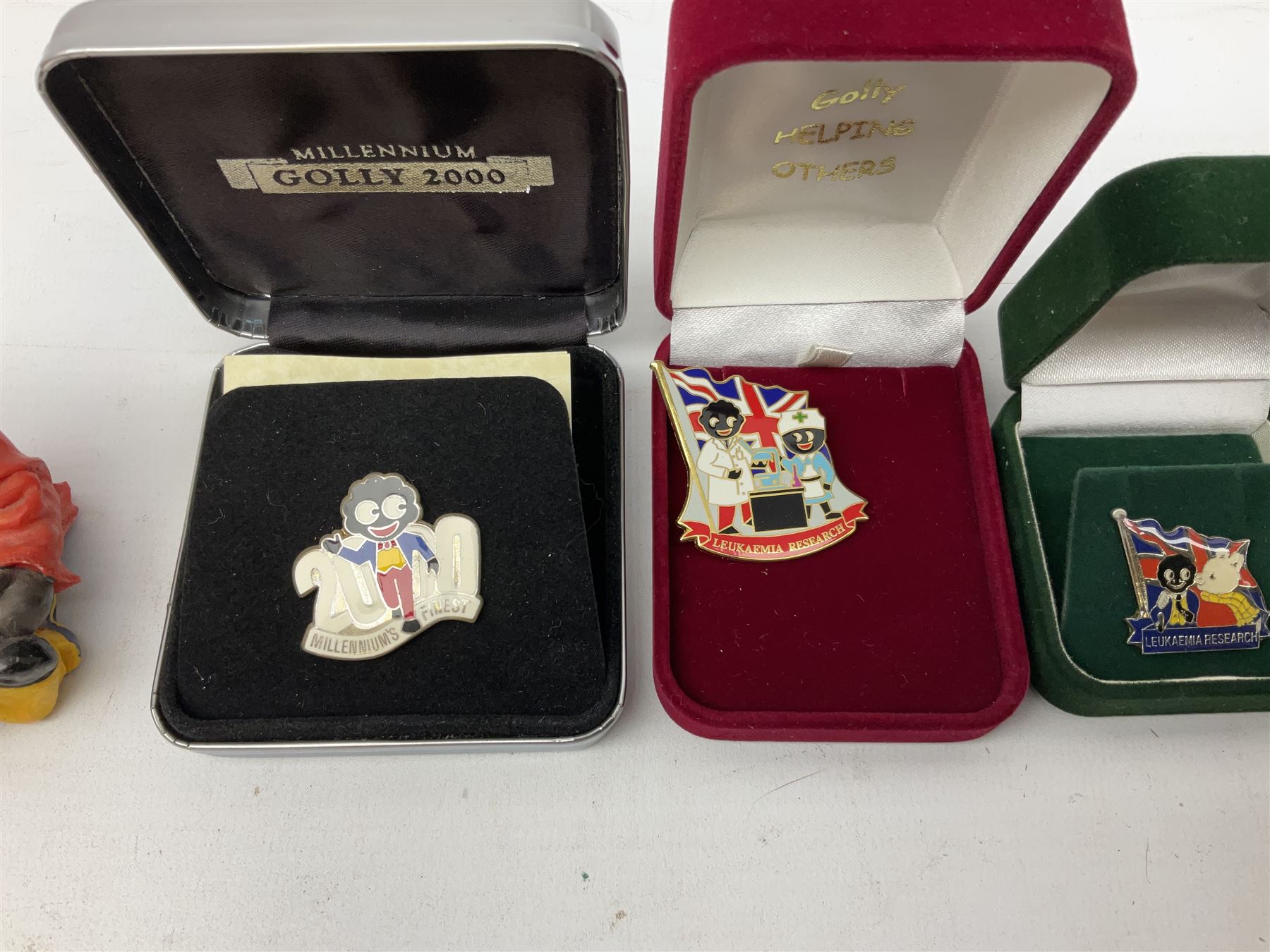 Eight ceramic Golly Band figurines marked Carlton Ware, together with four other Golly figures and five boxed badges