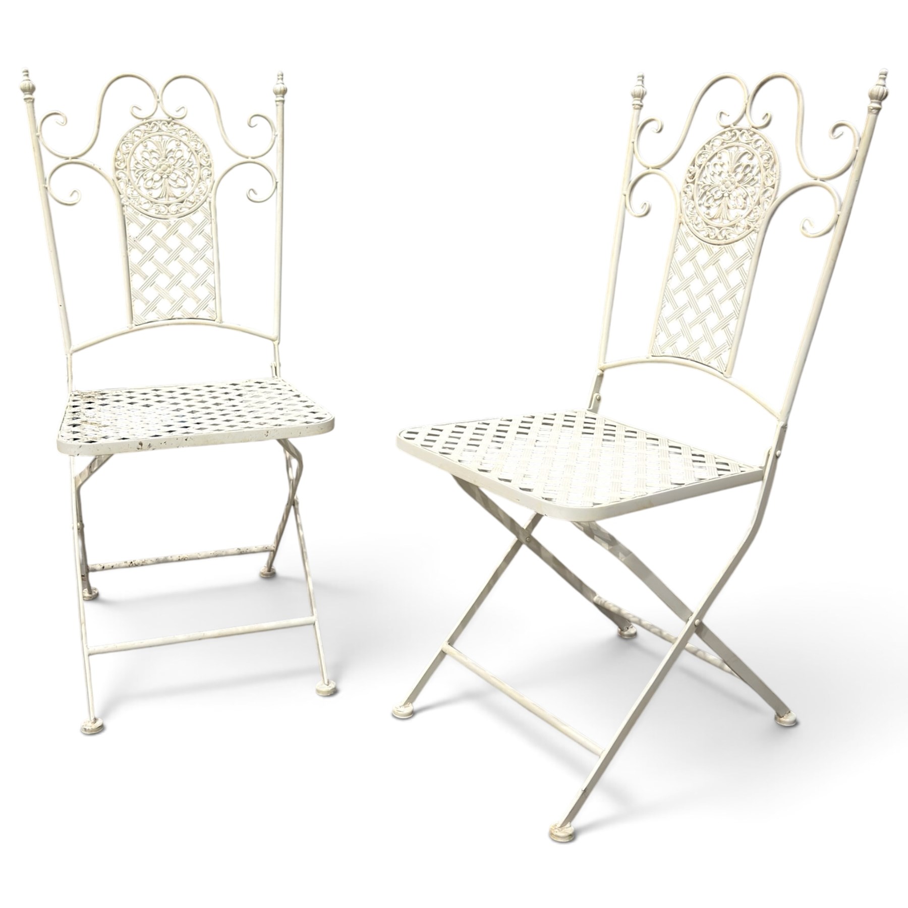 Pair of Victorian design wrought metal folding garden chairs, scrolled cresting rail over pierced foliate medallion, lattice back and seat on X-frame folding base