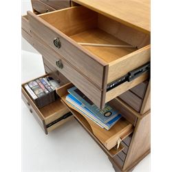 Teak multi-drawer music chest, fitted with eight drawers and four manuscript drawers with fall fronts, with contents