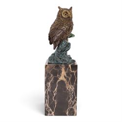 Cold painted bronze figure, modelled as an owl perched upon a tree stump signed Milo and with foundry mark, raised upon black veined marble plinth, H28cm