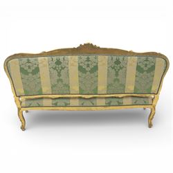 20th century French Louis XV style giltwood salon sofa, with shaped and moulded serpentine cresting rail carved with central scroll motif, padded back and seat upholstered in green and gold striped damask fabric, scroll carved open arms with padded rests, shaped apron carved with rocaille and foliate motifs, raised upon cabriole legs