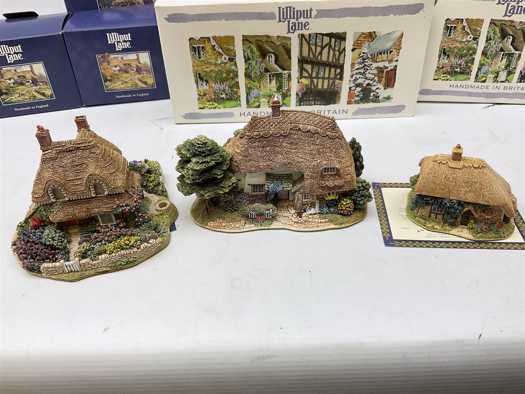 Eight Lilliput Lane models, including Gertrude's garden, Cruck End, Honeysuckle cottage, The Pottery, Huddersfield Railway Station, The Magpie Cafe, Amberly Rose, Summer Days and Shades of Summer, all boxed with deeds