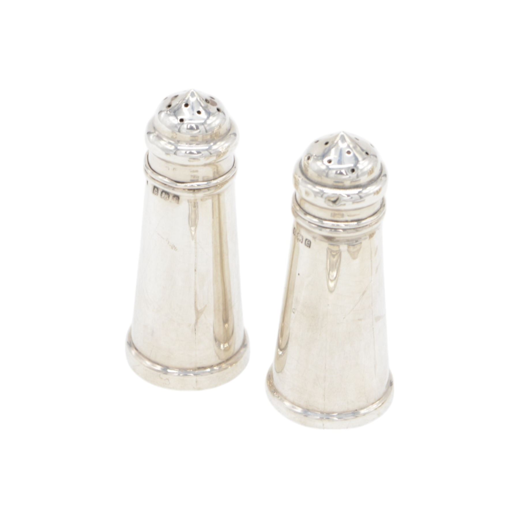 Group of silver cruet items, comprising pair of Art Deco salt and pepper shakers, of tapering cylindrical form, hallmarked Viner's Ltd, Sheffield 1933, pair of silver open salts, pair of salt shaker, and a matching pepper shaker and open salt, all hallmarked