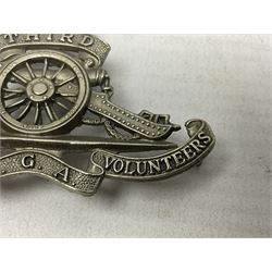 Third Middlesex Royal Garrison Artillery Volunteers Cap Badge, white meta Royal Artillery cap badge with “THIRD” to the top scroll and lower three part scroll “MIDDLESEX – R.G.A. – VOLUNTEERS”. Three lug fittings to the reverse.
