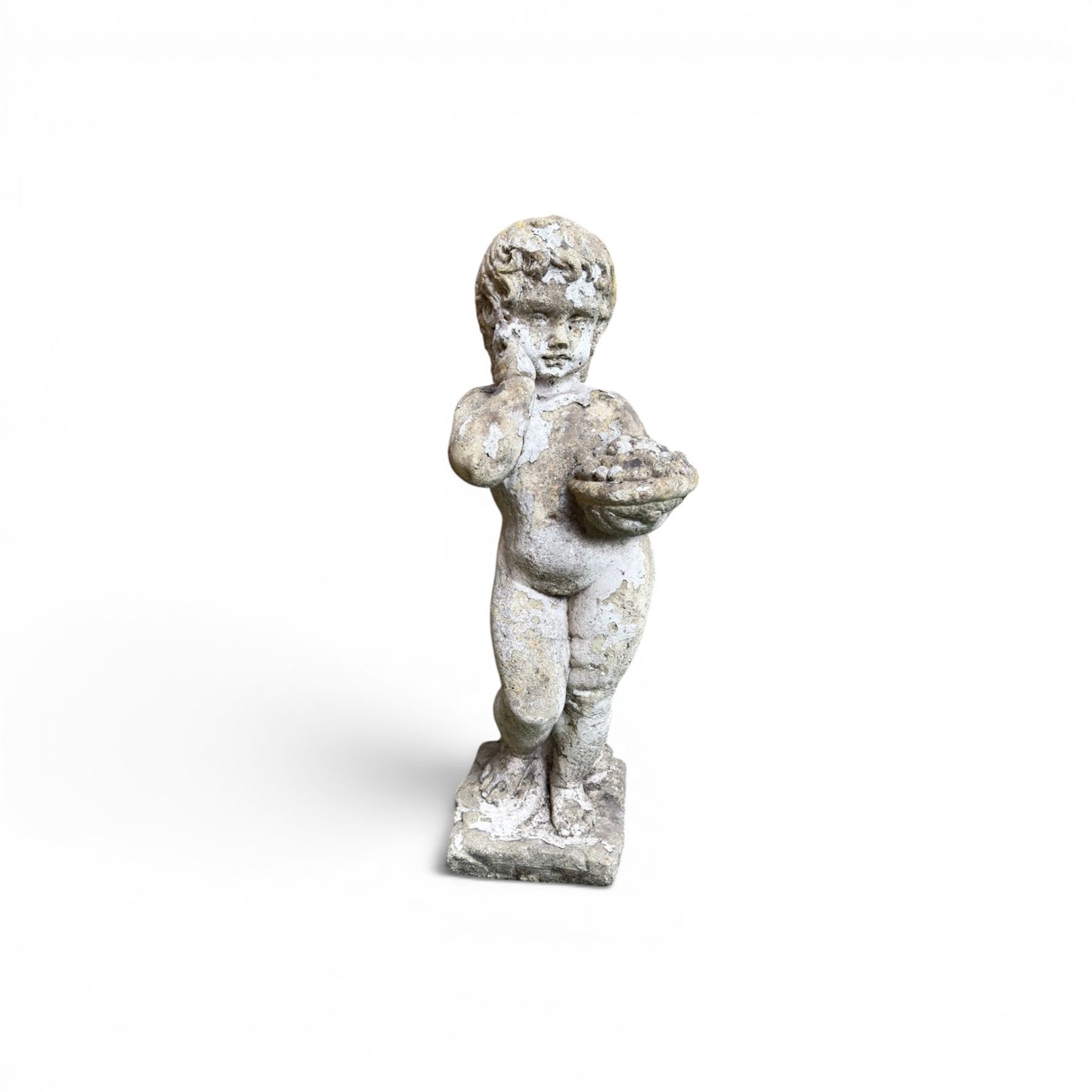 Early composition stone figure of a boy with grape basket, original flakey white paint