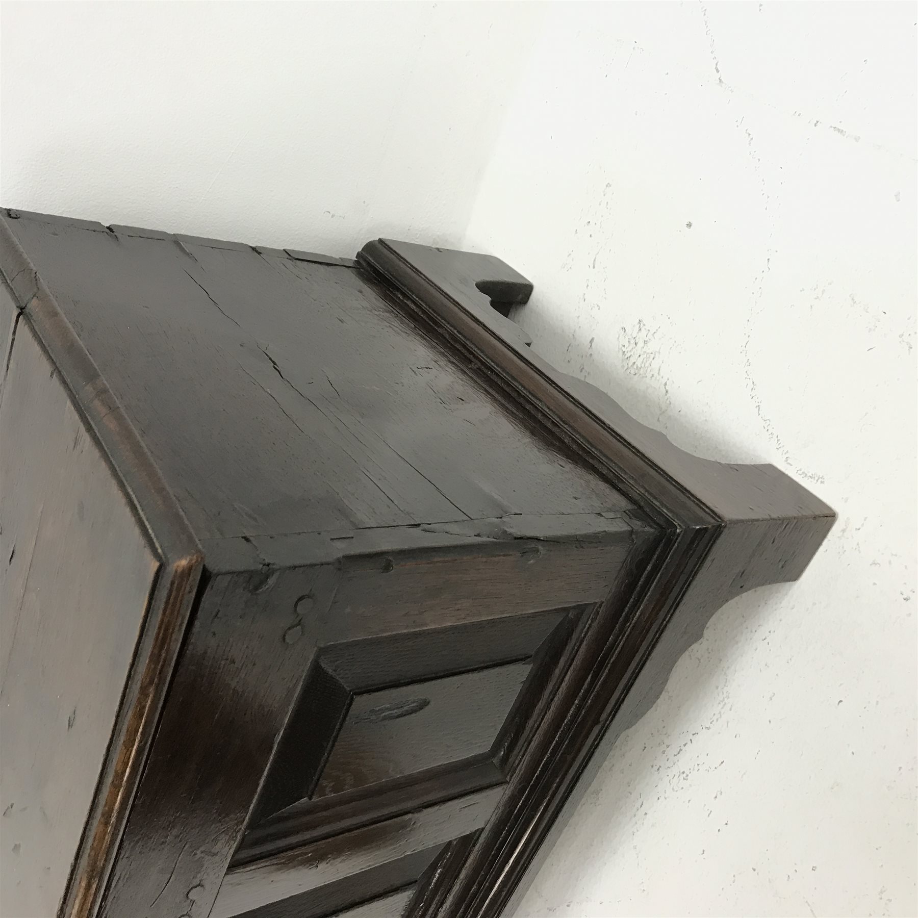 18th century oak coffer bach, the moulded hinged top above triple paneled front, on bracket feet, W63cm, H42cm, D36cm