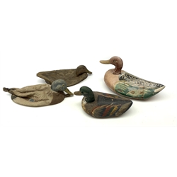Two graduated painted wooden decoy ducks, largest L33cm; and two similar rubber decoy ducks (4)