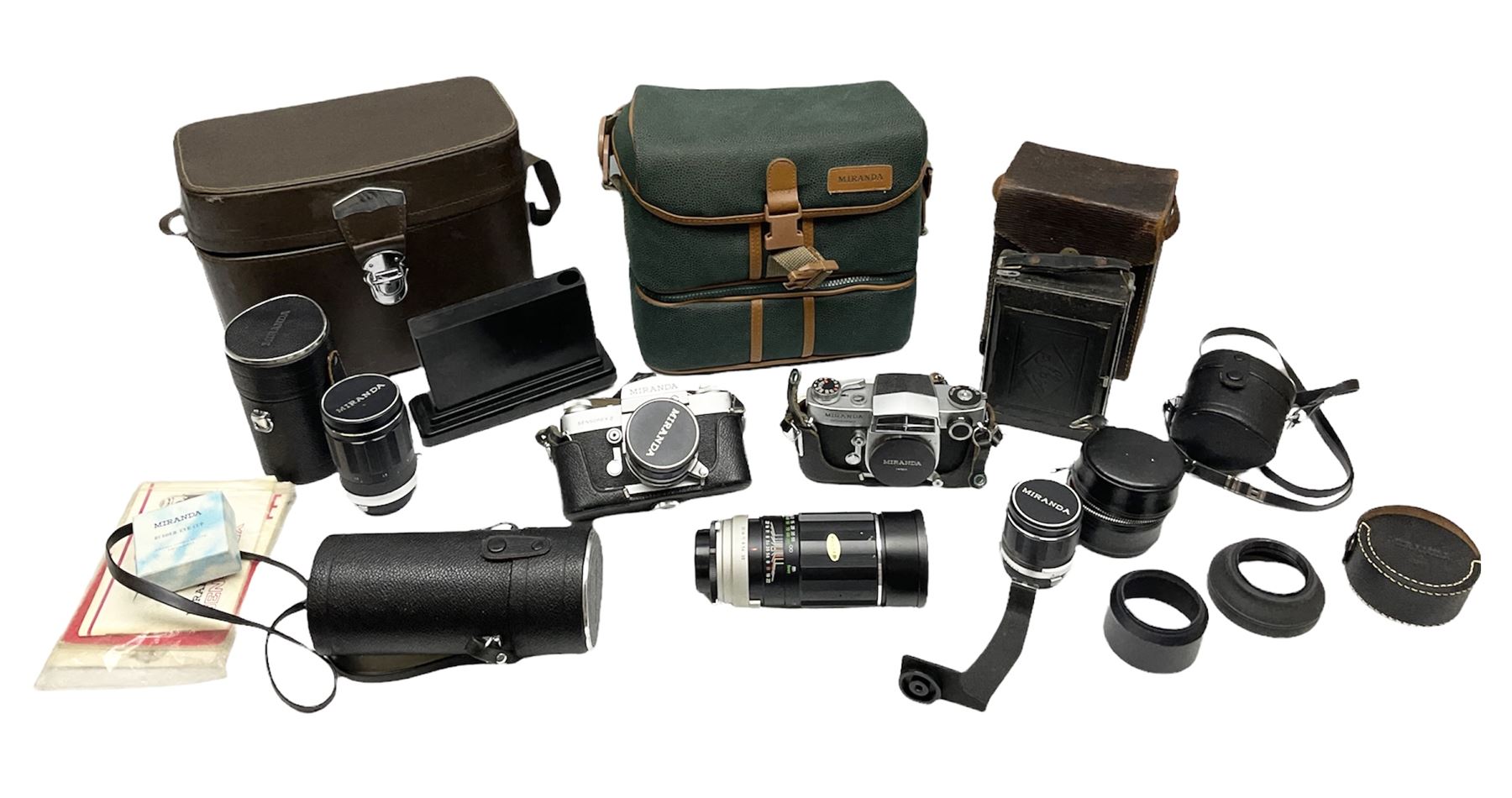 Miranda Sensorex camera body, Miranda Sensorex II camera body with 'Auto Miranda 1:1.8 f-59mm' lens, 'Auto Miranda 1:2.8 f-135mm' lens, 'Auto Miranda 1:3.5 f-200mm' lens, 'Auto Miranda 1:2.8 f-28mm' len, Agfa plate camera with 9cm x 12cm plates and other camera equipment including Miranda camera bag