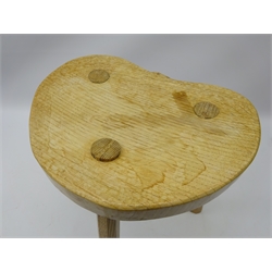  'Rabbitman' oak three legged stool, shaped dished seat carved with Rabbit signature, on faceted outsplayed supports, by Peter Heap of Wetwang, H37cm, W30cm  