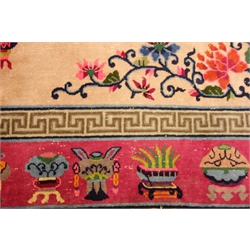  Early 20th century Chinese carpet, floral medallion, pink ground border decorated with urns and plants, 250cm x 269cm  