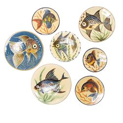 Puigdemont studio pottery slipware chargers, each uniquely decorated with stylised fish, l...