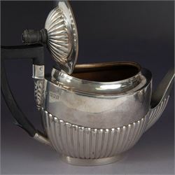 Victorian silver bachelors teapot, of part fluted oval form with ebonised wooden handle and finial, hallmarked Thomas Bradbury & Sons, London 1896, together with a Edwardian silver milk jug and open sucrier, of similar form with oblique gadrooned rims, hallmarked George Unite, Birmingham 1902 & 1906