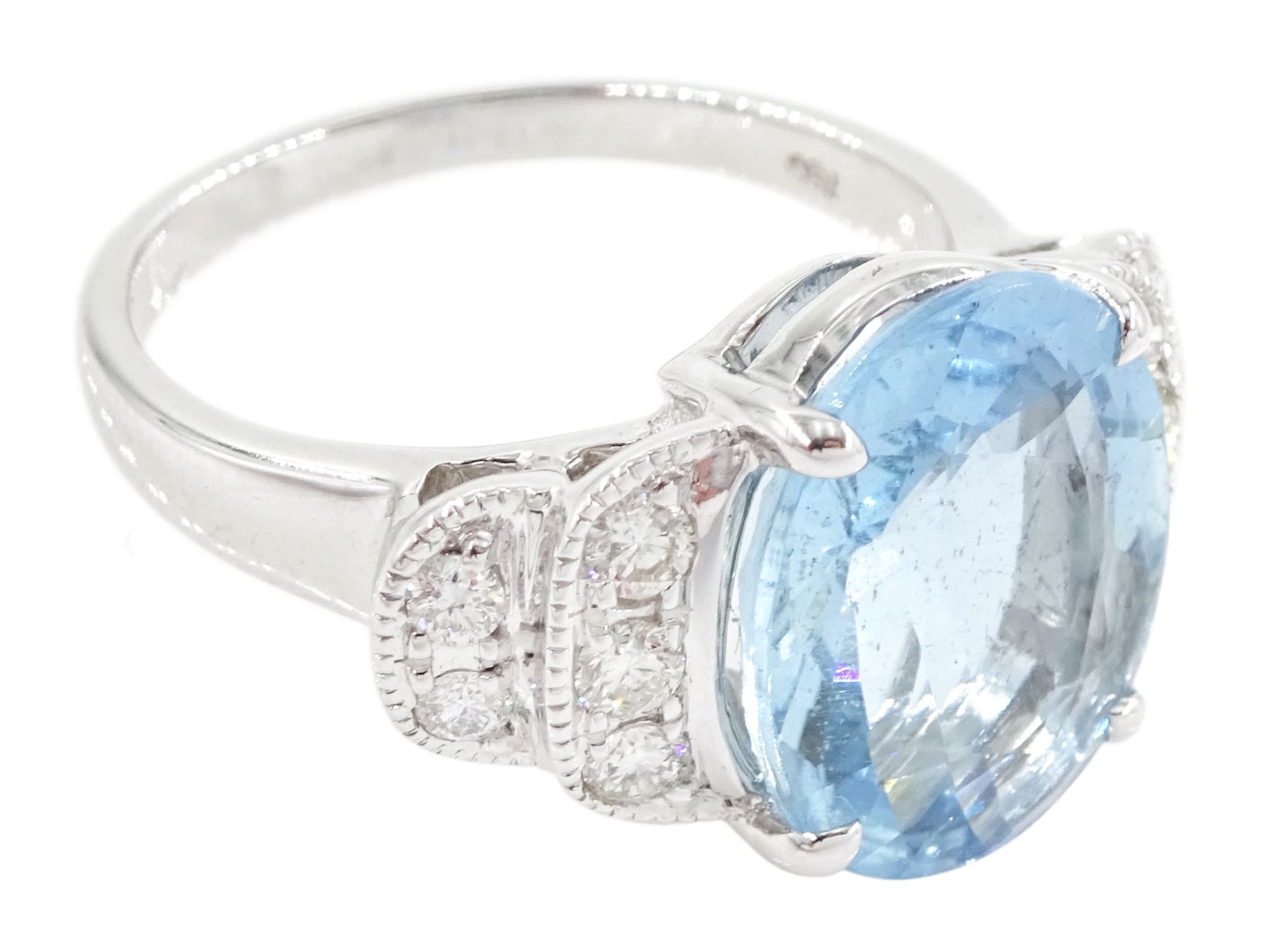 18ct white oval cut aquamarine ring, with milgrain set diamond, stepped design shoulders, stamped 750, aquamarine approx 4.55 carat, total diamond weight 0.35 carat