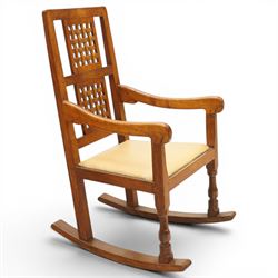 Mouseman - 1940's dark-honey oak rocking chair, high back with pierced double-lattice panel, over a beige-leather upholstered seat, shaped arm terminals above turned octagonal front-supports united by rocker base, with carved mouse signature, by the workshop of Robert Thompson of Kilburn