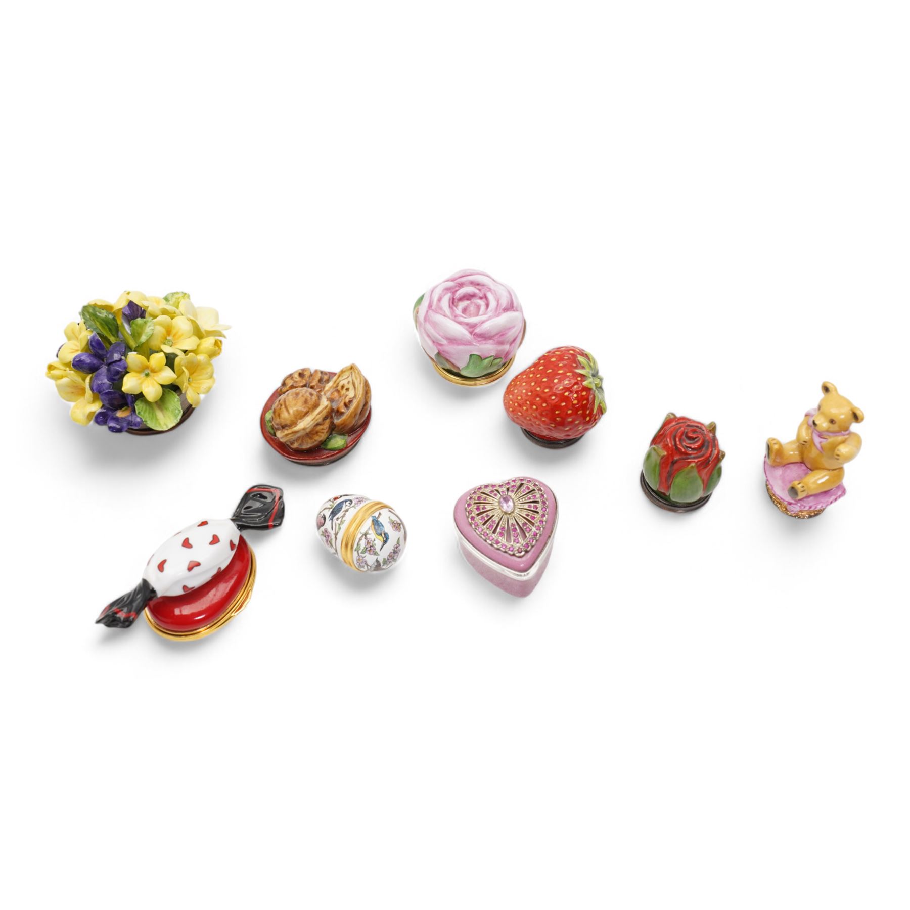 Halcyon Days enamel trinket boxes including 'My Sweetheart', Strawberry, Fabergé inspired heart-shaped box, small egg-shaped box, Rosebud, 'Primroses & Violets' etc, together with a porcelain model of a Teddy bear with agate base (9)