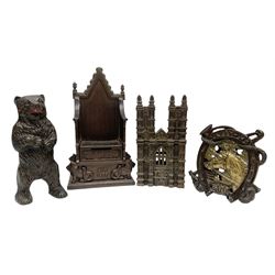 Four cast-iron money banks - 'Bear On Hind Legs bank' c1906 H16cm; 'ERII English Throne Bank' 1953 H21cm; both made by John Harper; 'Tally-Ho Bank' c1906 by Chamberlain & Hill H11.5cm; and 'Westminster Abbey Bank' c1908 by Sydenham & McCoustra H16cm (4)