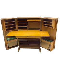 Mid-20th century walnut 'Magic Box' design metamorphic desk cabinet, two doors open to reveal sliding desk with drop leaves, document divisions and internal lamp, on sledge supports 
