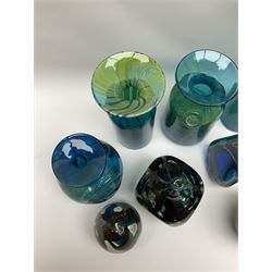 Quantity of M’dina art glass to include a streaked blue and green bottle form vase with captured bubble design and slender neck, H35cm, along with a paperweight, ovoid form vase and another vase all decorated in a blue, brown and white colour way, other contemporary glass examples etc with etched marks beneath