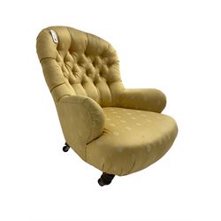 Victorian spoon back low armchair, upholstered in yellow buttoned fabric with sprung seat, raised on turned feet with castors