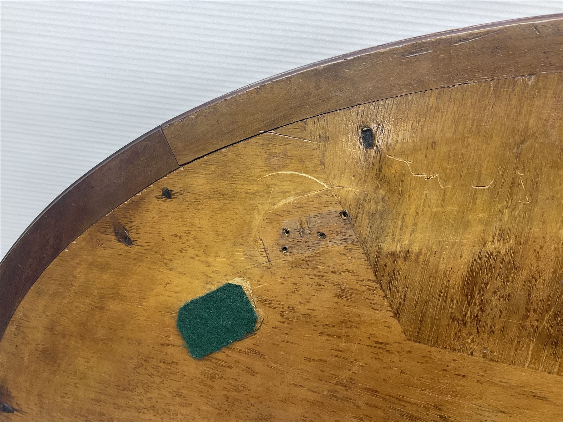 Late 19th/early 20th century mahogany and marquetry inlaid tray, of oval form with twin scrolled handles and moulded border, the central panel inlaid with figures seated at a table drinking tea, L99cm