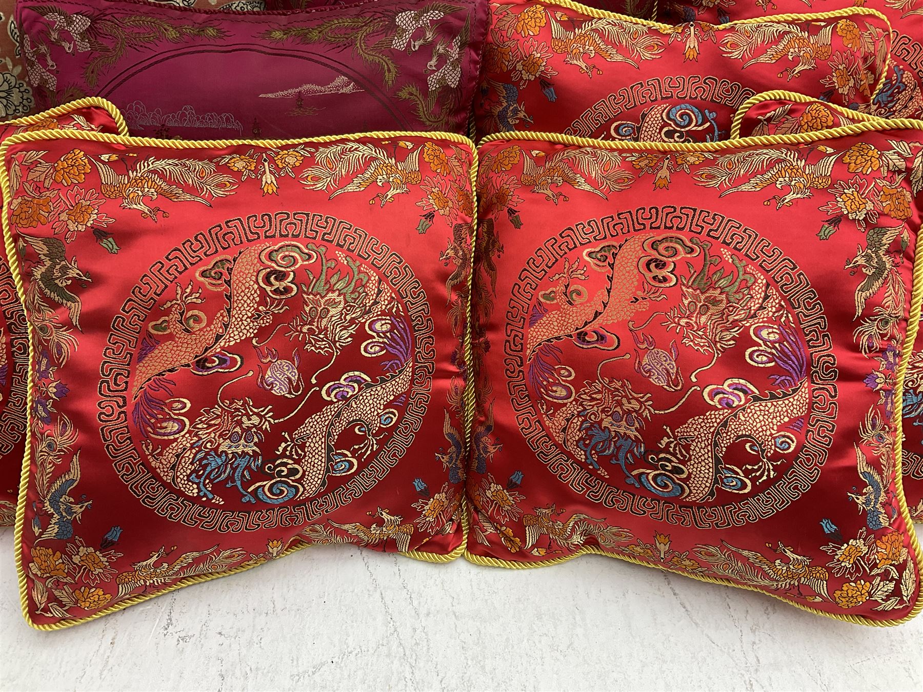 Collection of predominantly Chinese style cushions, to include feather down examples