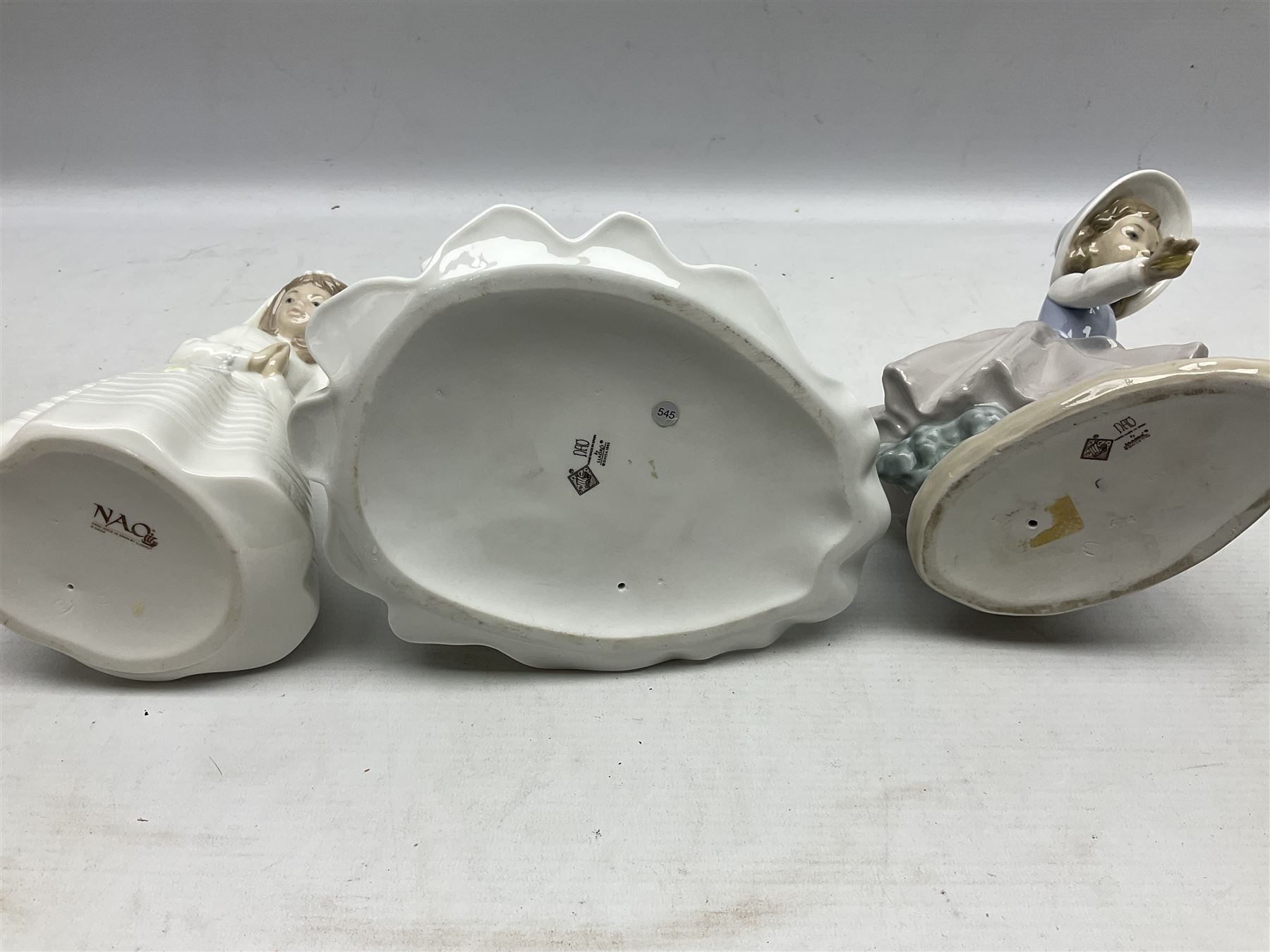 Three Nao figures comprising The Next Dance 1201 and Girls First Communion 0236, and young girl wearing a hat, together with two further Spanish style figures