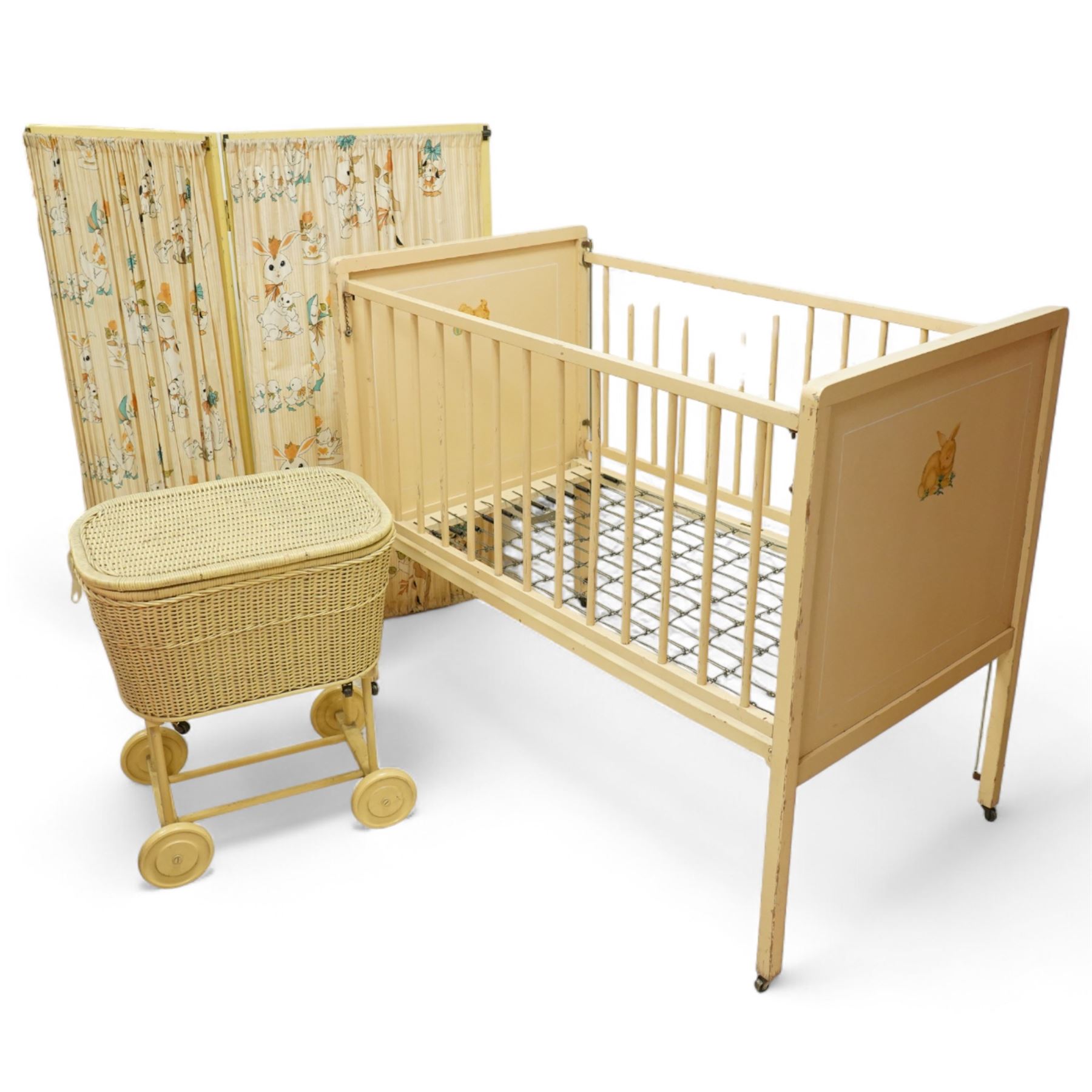 *Mid 20th century nursery set, comprising a cream painted metal cot with adjustable base, a wicker baby basket on wheeled stand, and a folding nursery screen with printed fabric panels decorated with playful animal and teddy bear motifs

Cot (H 112cm, W 136cm, D 77cm)
Screen (H 139cm, W 148cm) 
Basket (H 72cm, W 59cm, D 40cm)From the Kirkham Hall Attic & Cellar Collection, sold without reserve